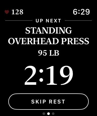 Your watch resting between lifts: Up Next, the Standing Overhead Press at 95 pounds, over a countdown at 2:19 and a Skip Rest button.